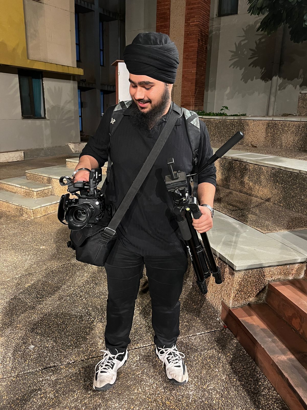 Simarpreet Singh on ground with camera gear